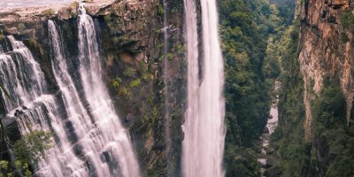 Dramatic view of a serene waterfall in Mpumalanga, surrounded by lush greenery.