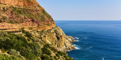 Beautiful coastal cliffs and ocean view in South Africa, showcasing nature's vibrant hues.